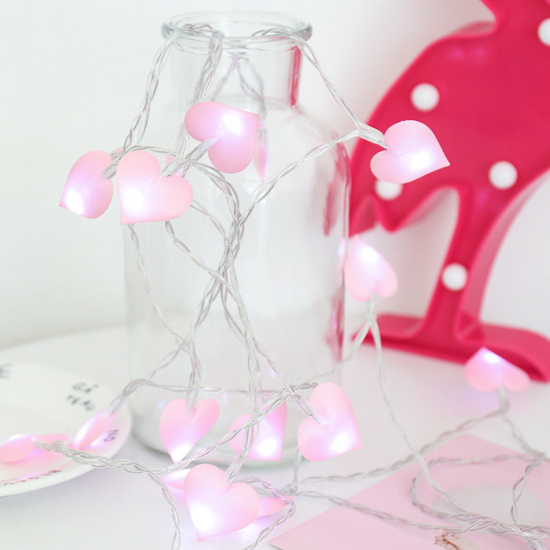 A string of warm, glowing Love Cotton lights, perfect for New Year and Christmas decor. The soft cotton spheres emit a cozy ambiance, ideal for festive celebrations and holiday decorations.