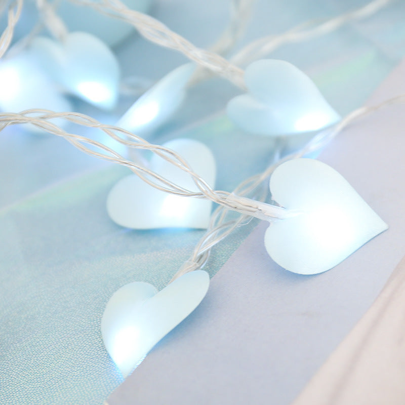 A string of warm, glowing Love Cotton lights, perfect for New Year and Christmas decor. The soft cotton spheres emit a cozy ambiance, ideal for festive celebrations and holiday decorations.